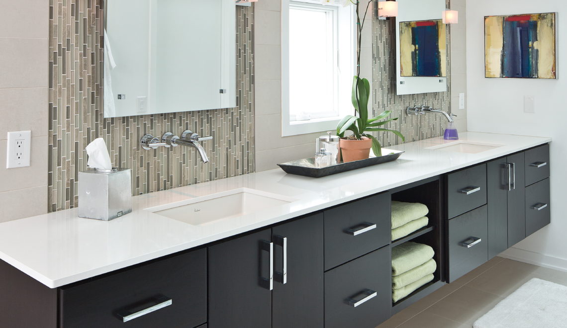 Accessible bathroom with dual vanity and floating cabinets.