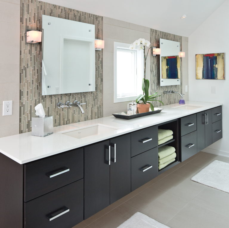 Accessible bathroom with dual vanity and floating cabinets.
