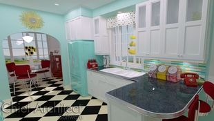 A throwback to another era, this retro kitchen has the checkered floor, chrome accents, vintage appliances, and bright whites, teals, and reds that reminisce of a 50's diner.